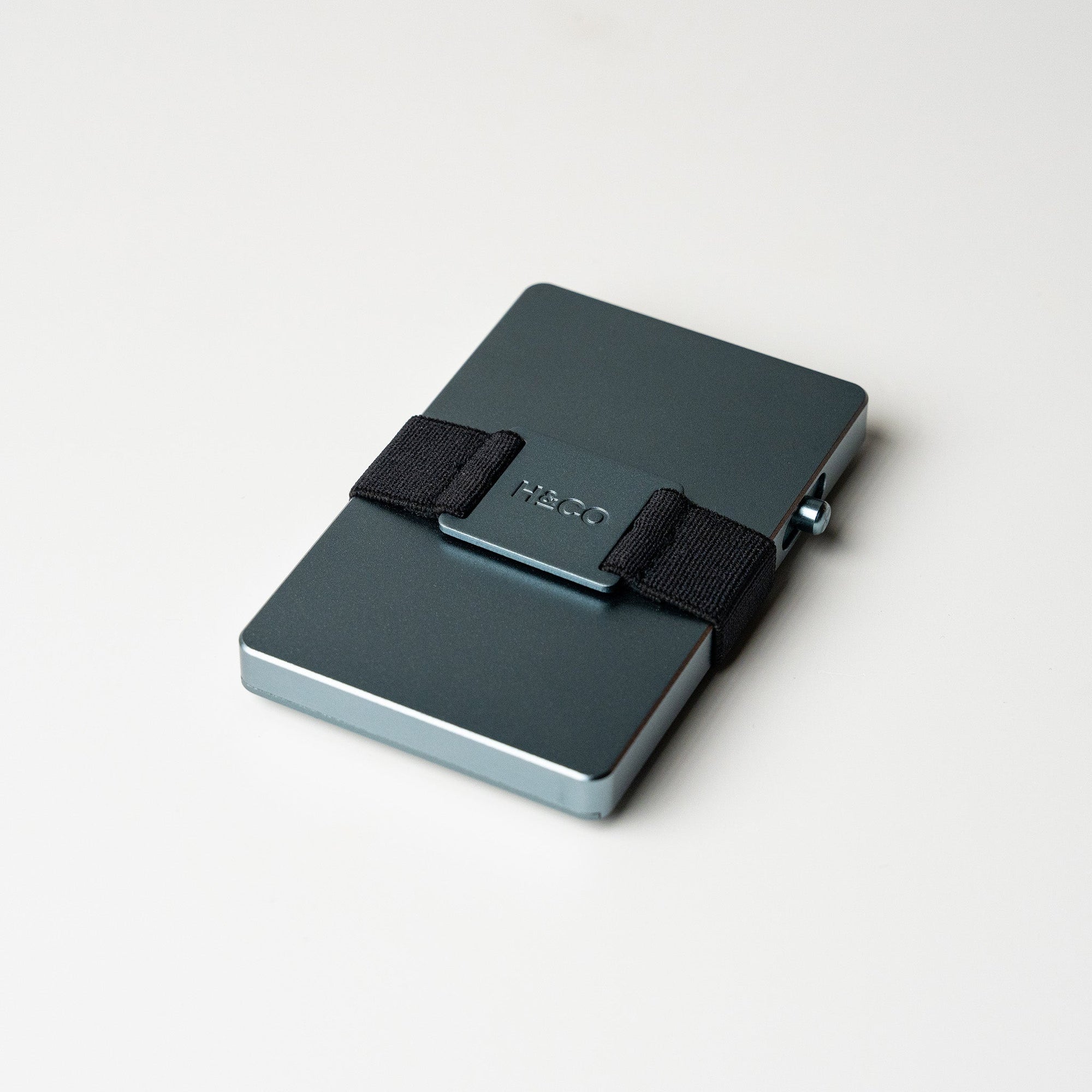 Steel Blue Evolve Smart Wallet with band on clean white background