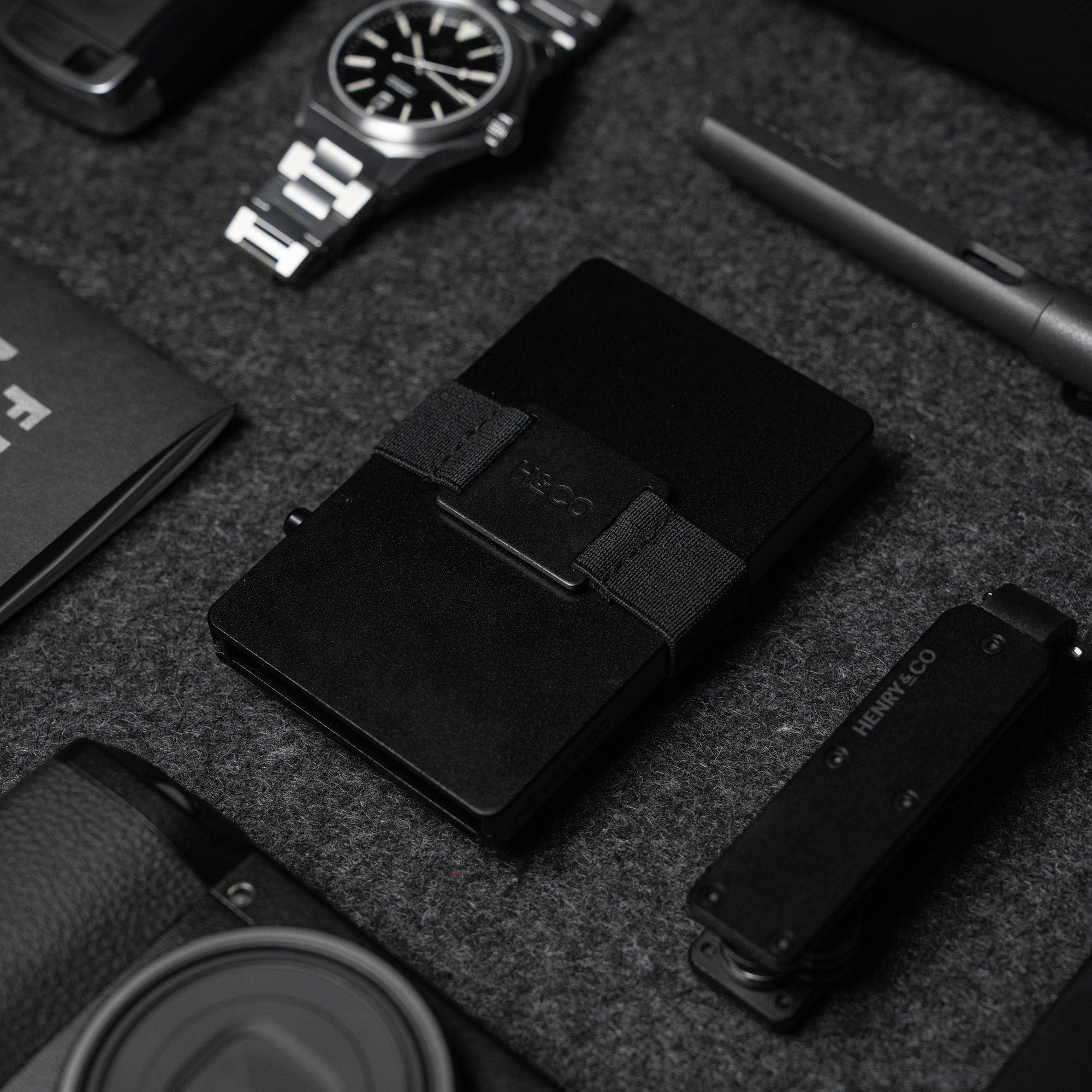 Midnight Black Vault Key Case styled with black Evolve Smart Wallet and accessories