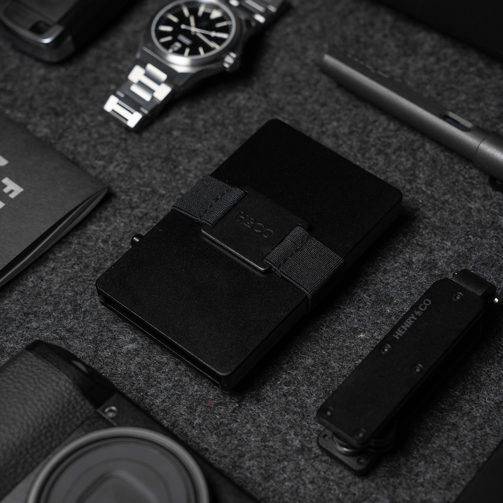 Midnight Black Vault Key Case styled with black Evolve Smart Wallet and accessories