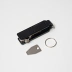 Midnight Black Vault Key Case flatlay with accessories on white background