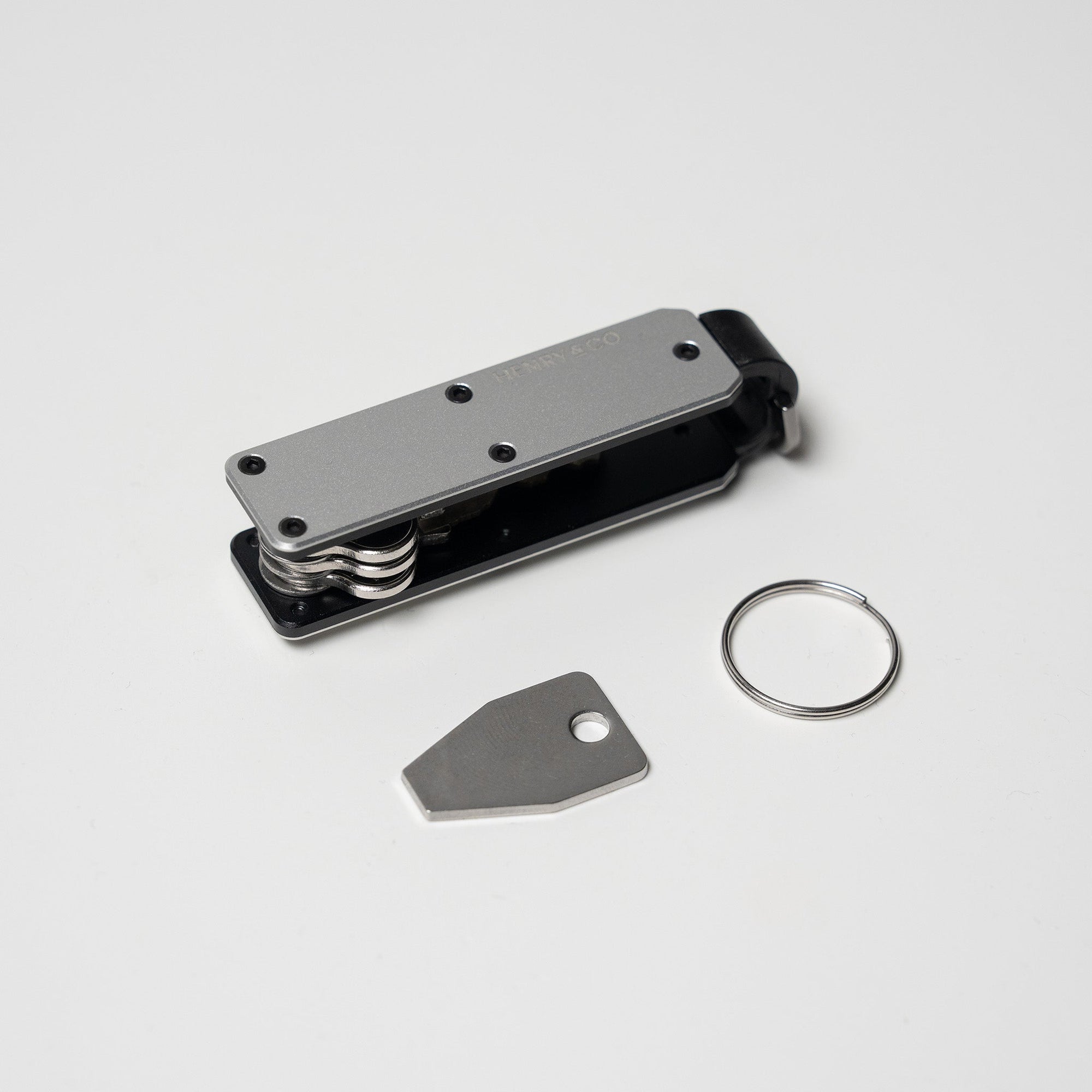 Platinum Vault Key Case flatlay with accessories on white background