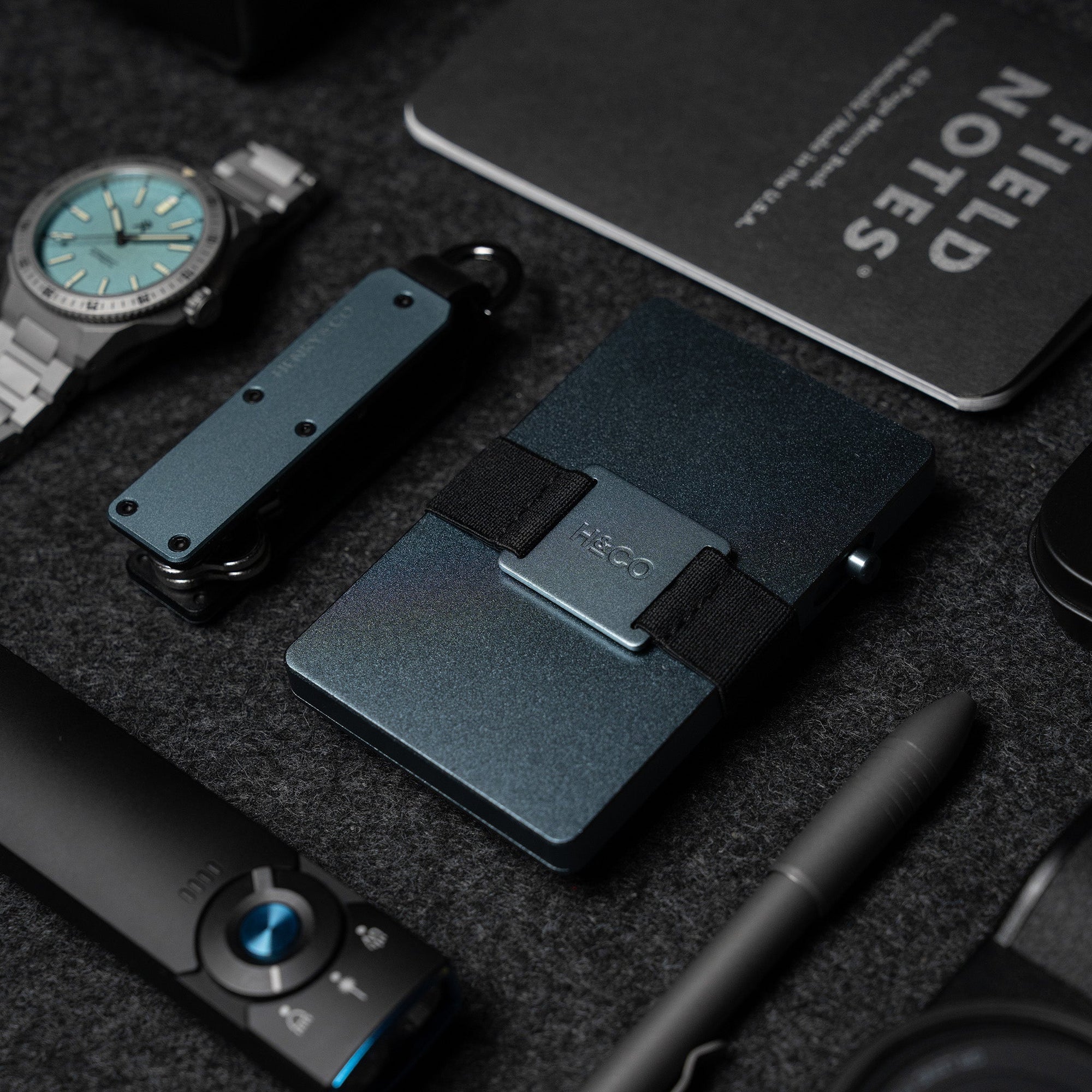 Steel Blue Vault Key Case styled on EDC flatlay with watch, pen and evolve wallet